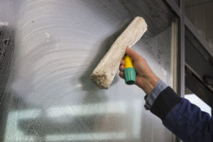 41381964 - hand cleaning window of a building, wash a window